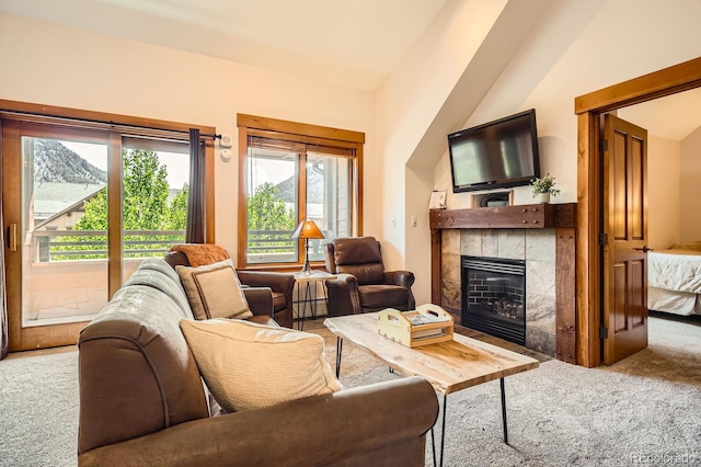 53 Hunki Dori Ct Unit 8905, Dillon, CO 80435 - living room with carpet flooring, a tiled fireplace, healthy amount of natural light, lofted ceiling, and a baseboard heating unit