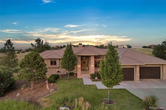 view of front of property with a yard and a garage