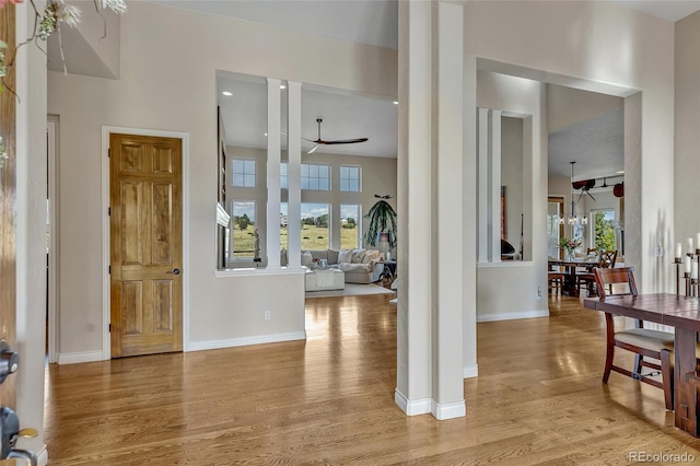 foyer entrance featuring ceiling fan, light hardwood / wood-style floors, and a wealth of natural light