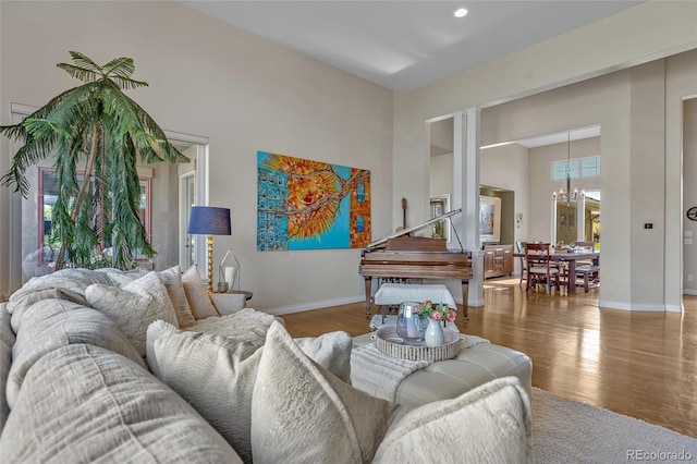 living room featuring an inviting chandelier and hardwood / wood-style floors