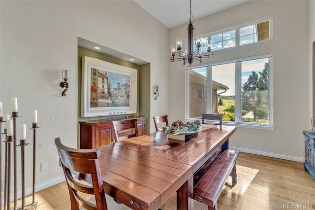 dining area with a notable chandelier and light hardwood / wood-style floors