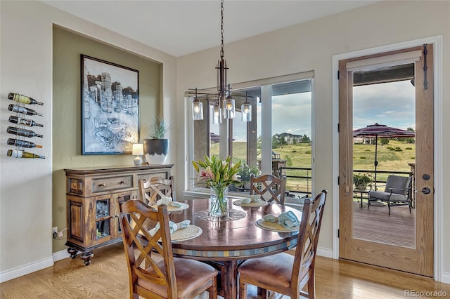 dining room with a notable chandelier and light hardwood / wood-style flooring