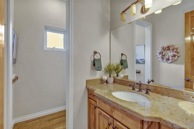 bathroom with vanity and hardwood / wood-style flooring