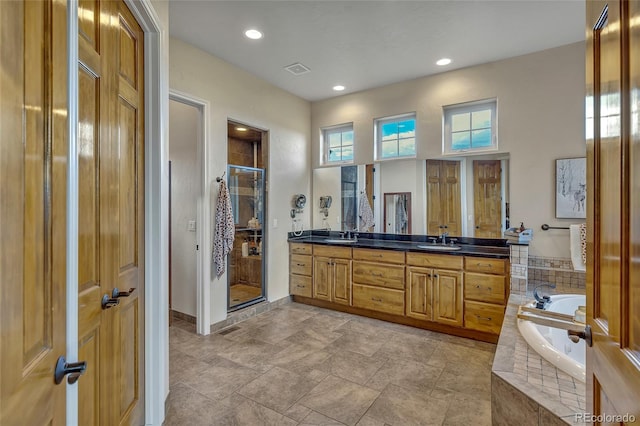 bathroom featuring vanity and plus walk in shower