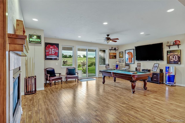 rec room with light hardwood / wood-style floors, ceiling fan, and billiards