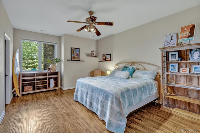 bedroom with ceiling fan and light hardwood / wood-style flooring