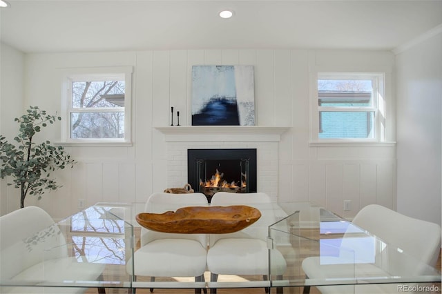 dining space featuring a brick fireplace and recessed lighting