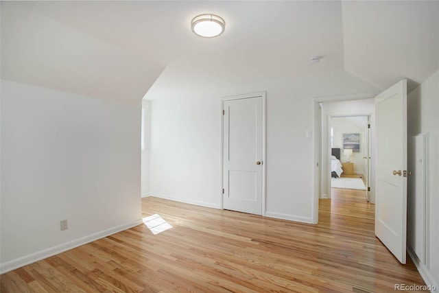 additional living space featuring light wood finished floors and baseboards