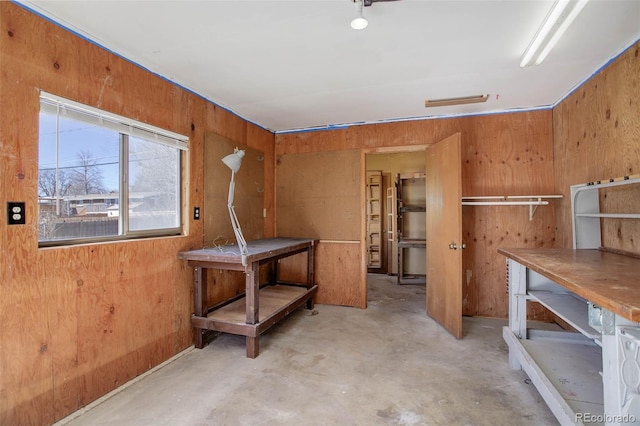 interior space featuring a workshop area and wooden walls