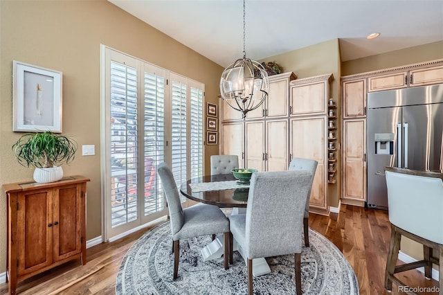 dining space featuring plenty of natural light, a chandelier, and dark hardwood / wood-style flooring