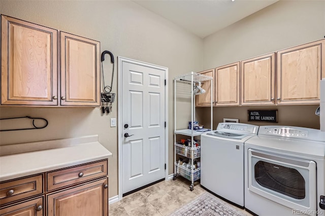 laundry area featuring washer and dryer and cabinets