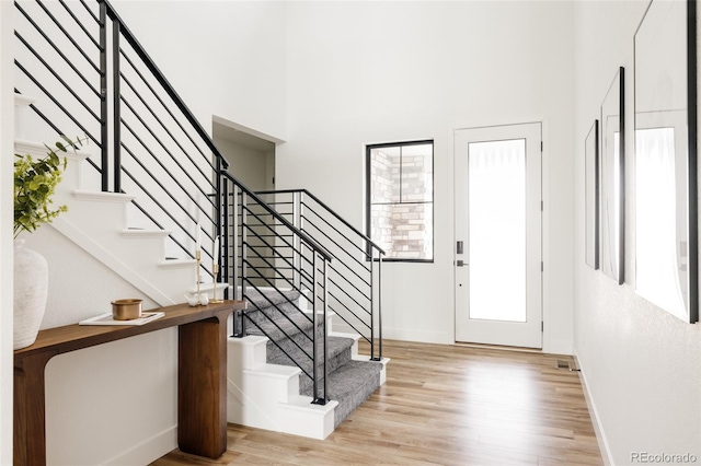 17252 Rose Mallow Ave, Parker, CO 80134 - foyer entrance with wood finished floors, a towering ceiling, baseboards, and stairway