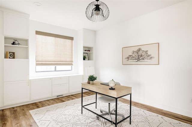 17252 Rose Mallow Ave, Parker, CO 80134 - office space featuring a chandelier, light wood finished floors, and baseboards