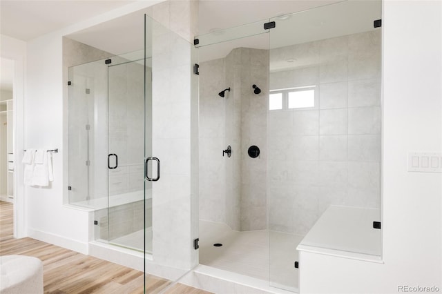 17252 Rose Mallow Ave, Parker, CO 80134 - bathroom with a stall shower, wood finished floors, and baseboards