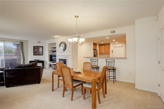 carpeted dining space with a fireplace, a chandelier, and built in shelves