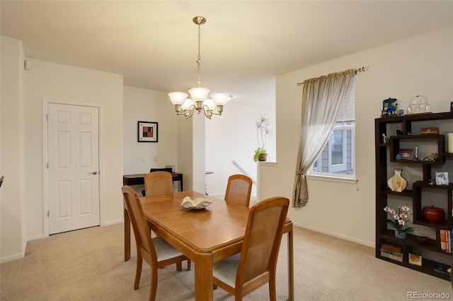 carpeted dining room with a chandelier