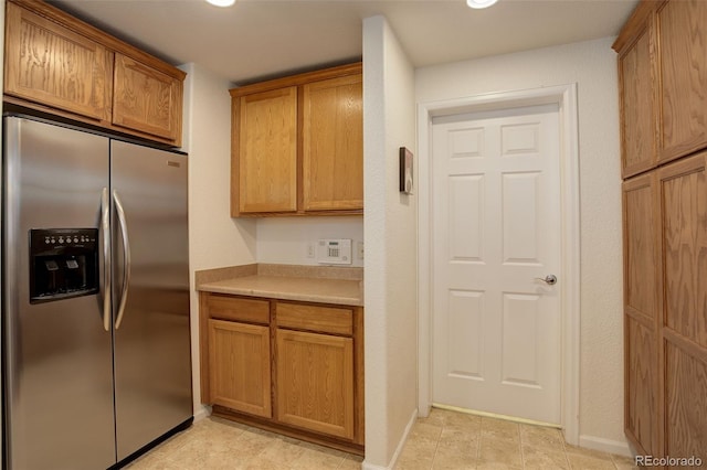 kitchen featuring stainless steel fridge with ice dispenser