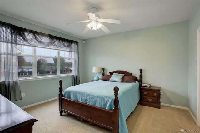 bedroom with ceiling fan and light carpet