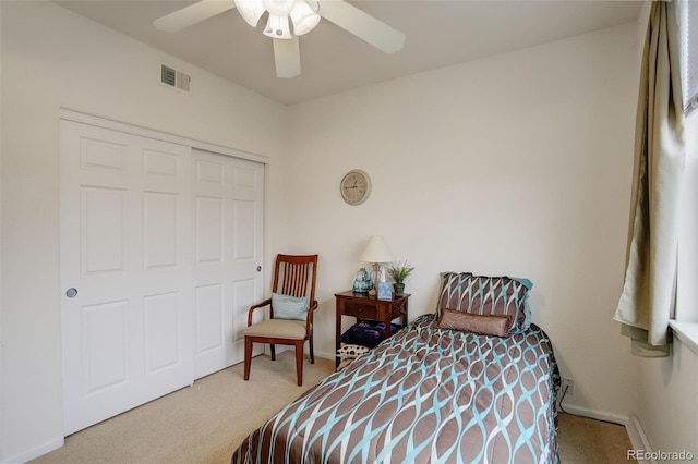 carpeted bedroom with a closet and ceiling fan