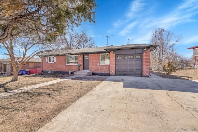 ranch-style home featuring driveway, a garage, and brick siding