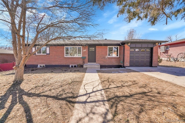 ranch-style home featuring brick siding, driveway, and an attached garage