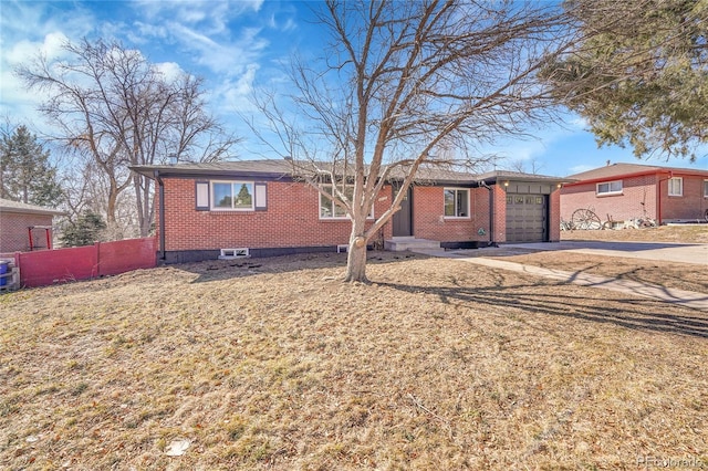 ranch-style home featuring an attached garage, driveway, fence, and brick siding