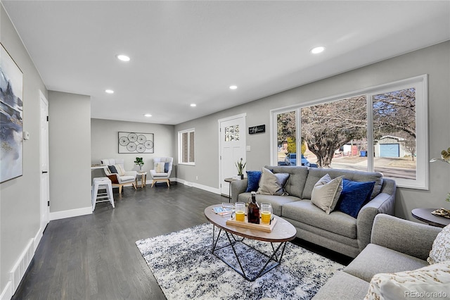 living room featuring recessed lighting, dark wood-style flooring, and baseboards