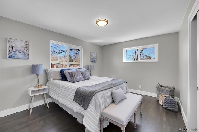 bedroom with dark wood-style floors and baseboards