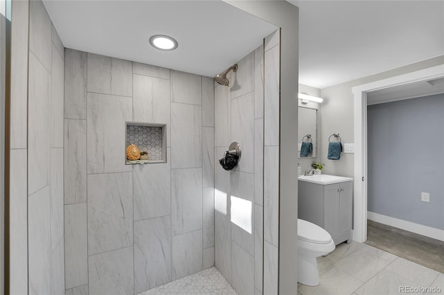 bathroom featuring baseboards, tiled shower, toilet, marble finish floor, and vanity