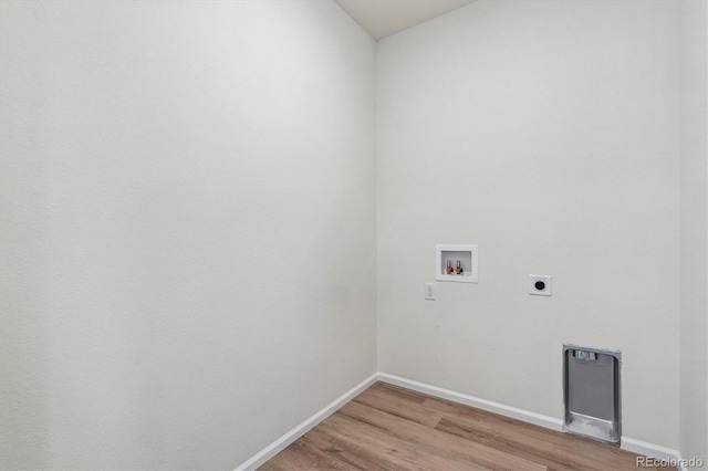 clothes washing area with electric dryer hookup, hookup for a washing machine, and wood-type flooring