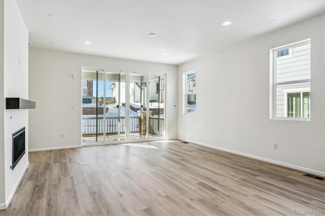 unfurnished living room with light hardwood / wood-style flooring