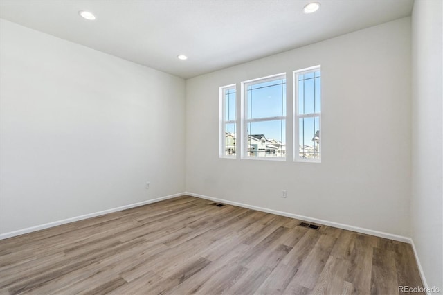 unfurnished room featuring light hardwood / wood-style flooring