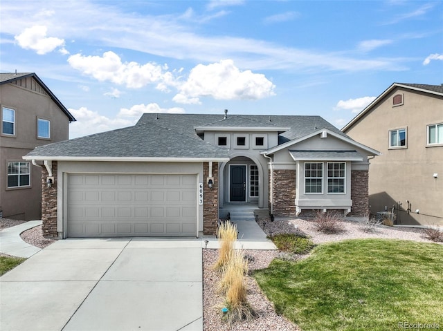 6093 Rowdy Dr, Colorado Springs, CO 80924 - view of front of house featuring concrete driveway, an attached garage, stone siding, and a shingled roof