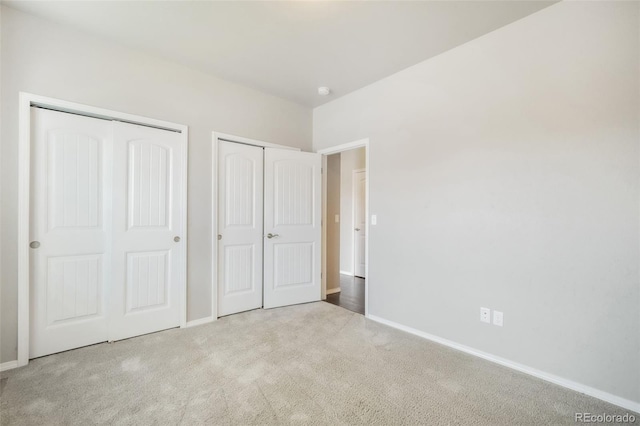 6093 Rowdy Dr, Colorado Springs, CO 80924 - unfurnished bedroom featuring two closets, carpet floors, and baseboards
