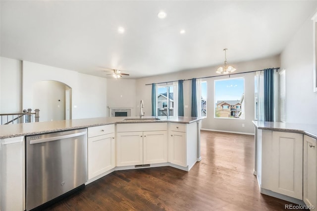 6093 Rowdy Dr, Colorado Springs, CO 80924 - kitchen featuring stainless steel dishwasher, arched walkways, a sink, dark wood finished floors, and ceiling fan with notable chandelier