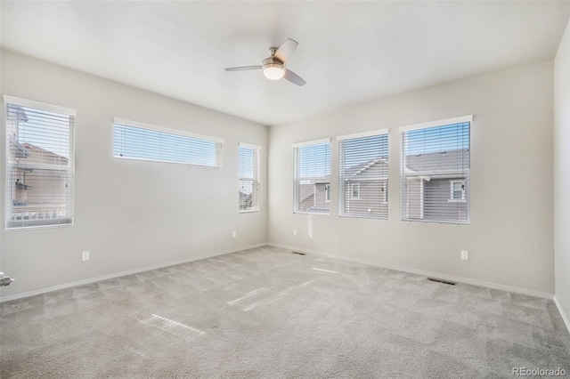 6093 Rowdy Dr, Colorado Springs, CO 80924 - unfurnished room featuring light colored carpet, ceiling fan, and a wealth of natural light