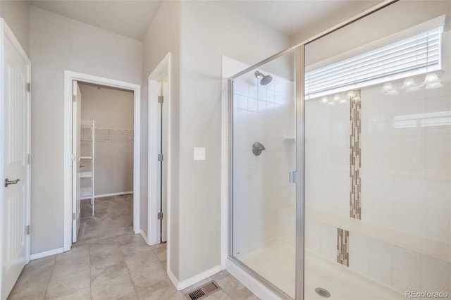 6093 Rowdy Dr, Colorado Springs, CO 80924 - full bath featuring a walk in closet, baseboards, visible vents, and a stall shower