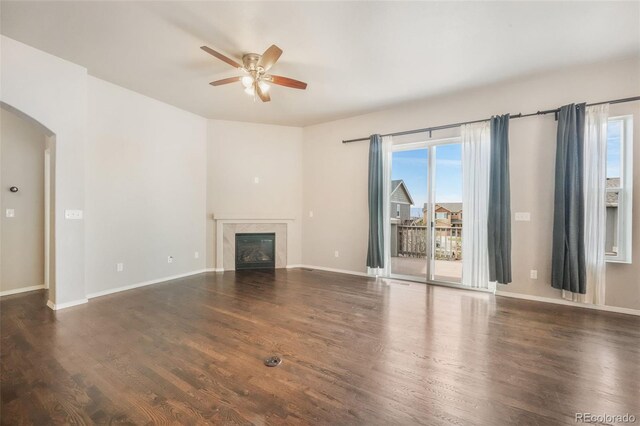 6093 Rowdy Dr, Colorado Springs, CO 80924 - unfurnished living room with arched walkways, plenty of natural light, a ceiling fan, and wood finished floors