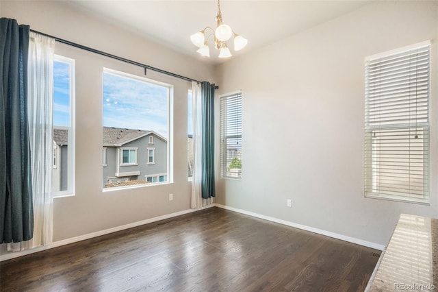 6093 Rowdy Dr, Colorado Springs, CO 80924 - empty room with baseboards, a chandelier, and dark wood-type flooring