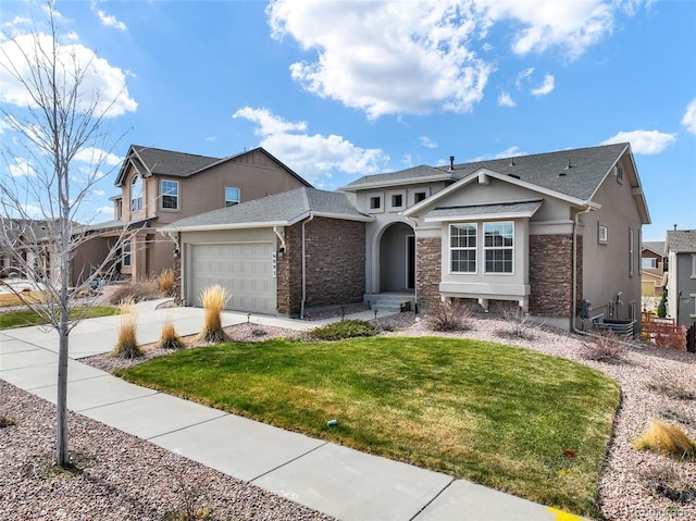 6093 Rowdy Dr, Colorado Springs, CO 80924 - view of front of home with a front lawn, driveway, stone siding, a garage, and stucco siding