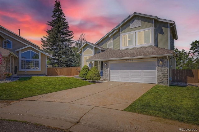 9385 Pepperwood Ln, Highlands Ranch, CO 80126 - view of front of home with concrete driveway, a garage, and stone siding