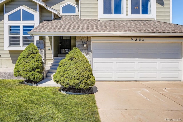 9385 Pepperwood Ln, Highlands Ranch, CO 80126 - view of front of home featuring concrete driveway, a garage, a shingled roof, and a front yard