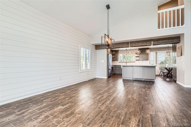 9385 Pepperwood Ln, Highlands Ranch, CO 80126 - unfurnished living room with a chandelier, dark wood-style flooring, and high vaulted ceiling
