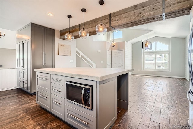 9385 Pepperwood Ln, Highlands Ranch, CO 80126 - kitchen with gray cabinetry, stainless steel microwave, a chandelier, dark wood finished floors, and recessed lighting