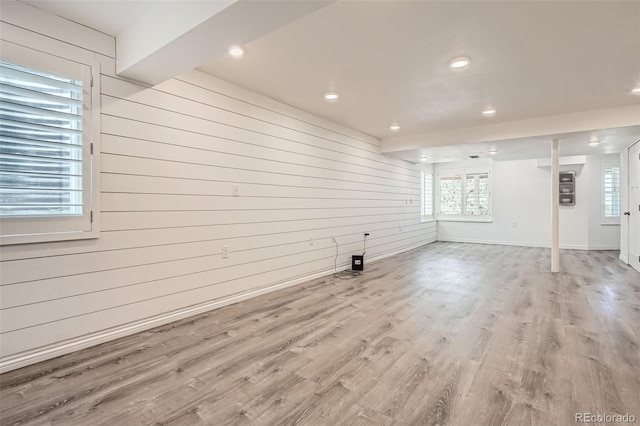 9385 Pepperwood Ln, Highlands Ranch, CO 80126 - empty room featuring wooden walls, wood finished floors, recessed lighting, and healthy amount of natural light