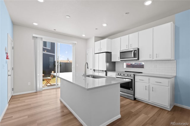 9257 Mayflower Gulch Way, Colorado Springs, CO 80927 - kitchen featuring stainless steel appliances, a sink, light wood-style flooring, backsplash, and recessed lighting