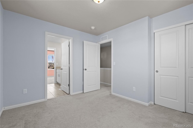 9257 Mayflower Gulch Way, Colorado Springs, CO 80927 - unfurnished bedroom with light colored carpet, baseboards, a closet, and ensuite bathroom