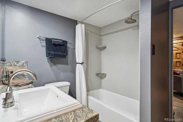bathroom with toilet, a sink, and shower / bathtub combination with curtain