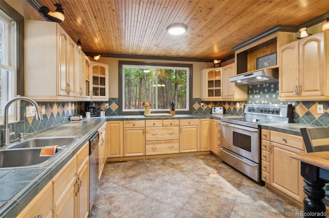 kitchen with light brown cabinets, under cabinet range hood, a sink, tile counters, and stainless steel appliances