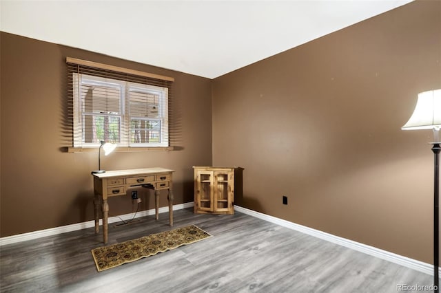 office space with baseboards and wood finished floors